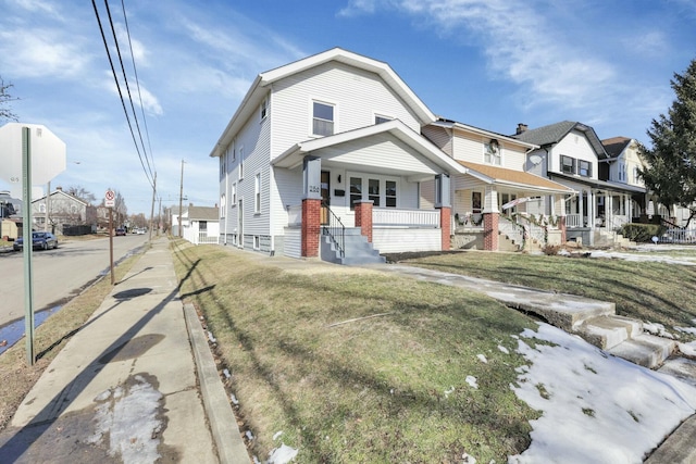 view of front of property with a front yard and covered porch