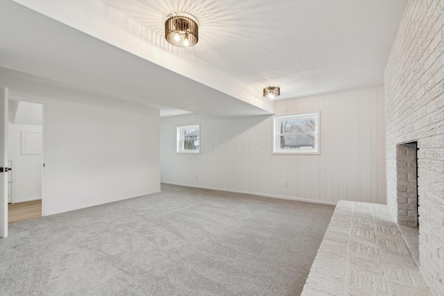 interior space featuring a brick fireplace and carpet flooring