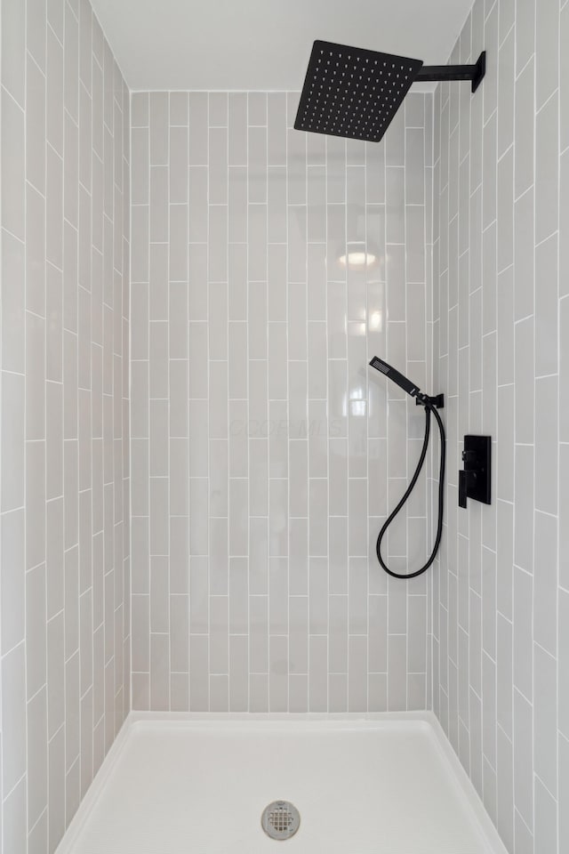 bathroom with tiled shower