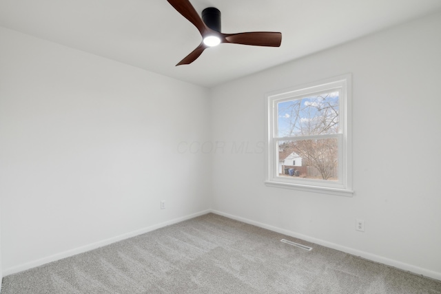 carpeted spare room with ceiling fan