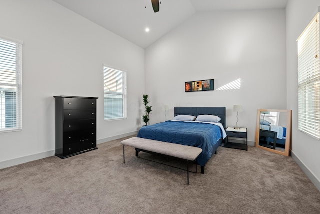 bedroom with ceiling fan, light carpet, and high vaulted ceiling