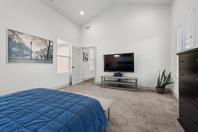 bedroom featuring high vaulted ceiling and carpet