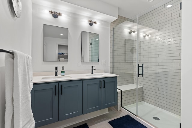 bathroom featuring tile patterned flooring, vanity, and a shower with door