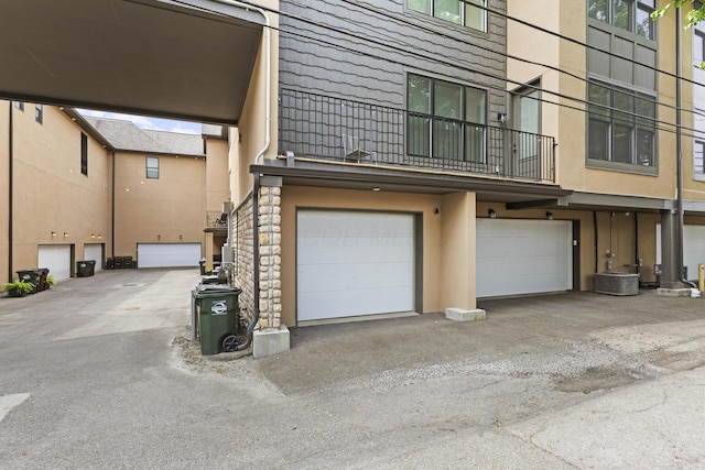 1078 Bryden Rd Unit 6, Columbus, OH 43205 - back of house with a balcony, a garage, and stucco siding