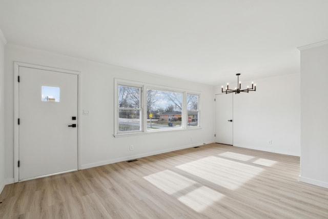 foyer entrance with an inviting chandelier and light wood-type flooring