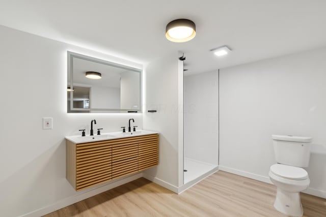 bathroom with vanity, hardwood / wood-style floors, toilet, and walk in shower