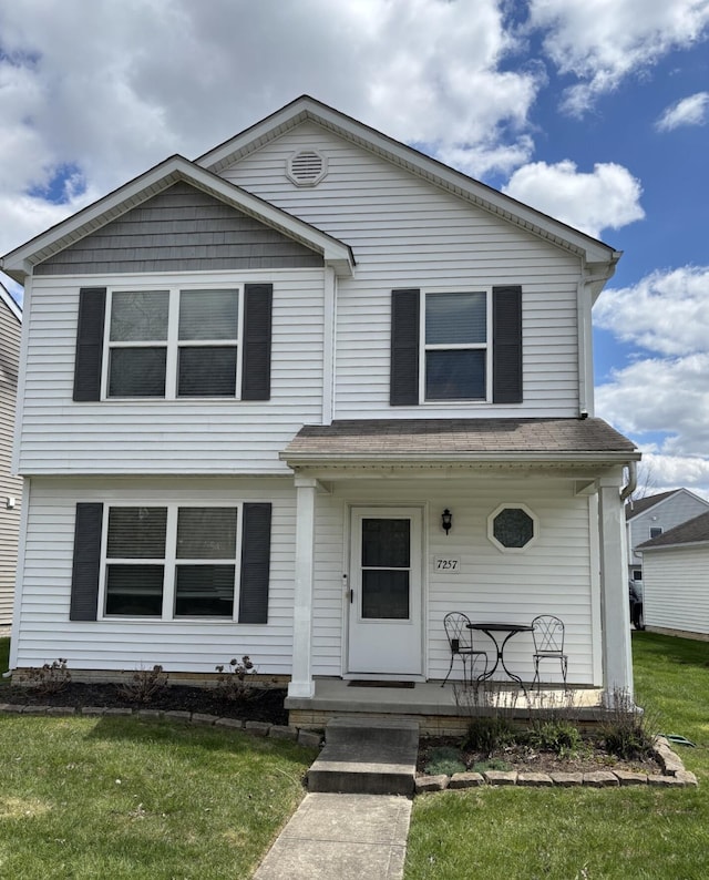 7257 Reynolds Crossing Dr, Reynoldsburg, OH 43068 - traditional-style house featuring a porch and a front lawn