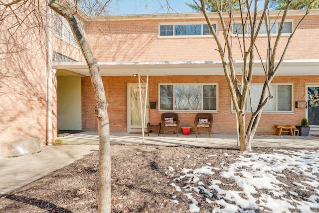 snow covered property with a patio area