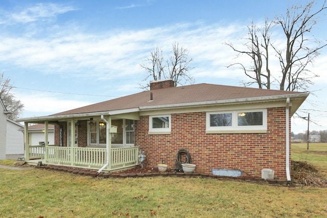 back of property with a porch and a lawn