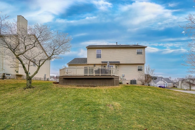 rear view of property with a wooden deck, a yard, and cooling unit