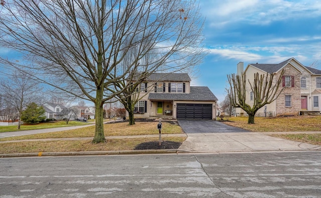 view of front of home featuring a garage and a front yard