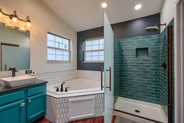 bathroom with lofted ceiling, vanity, and shower with separate bathtub