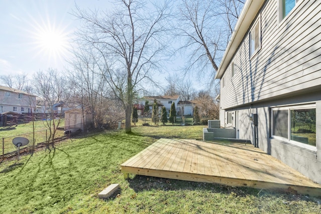 view of yard featuring central AC and a deck