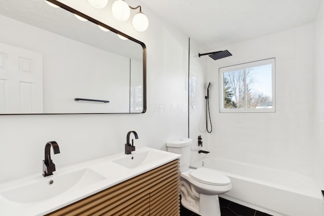 full bathroom with tile patterned floors, toilet, tiled shower / bath combo, and vanity