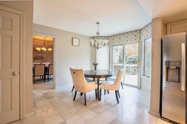 dining area with an inviting chandelier