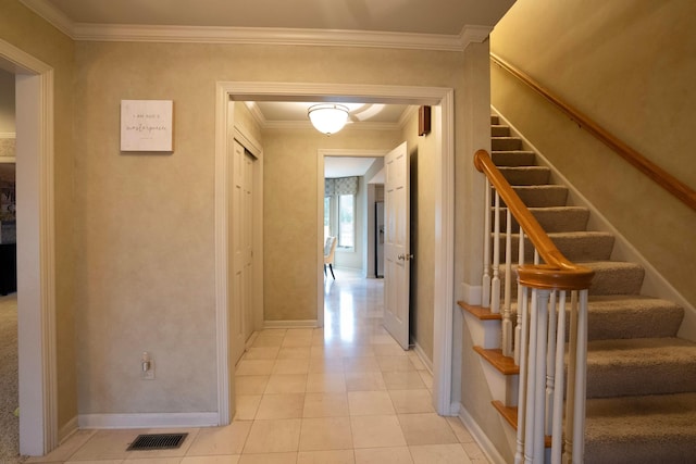 hall with crown molding and light tile patterned flooring