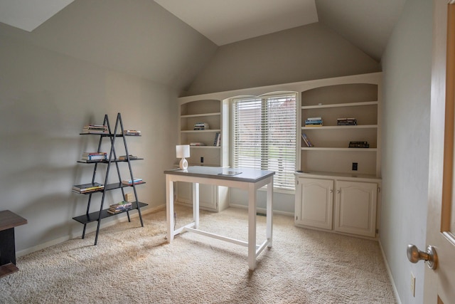 unfurnished office featuring lofted ceiling and light carpet