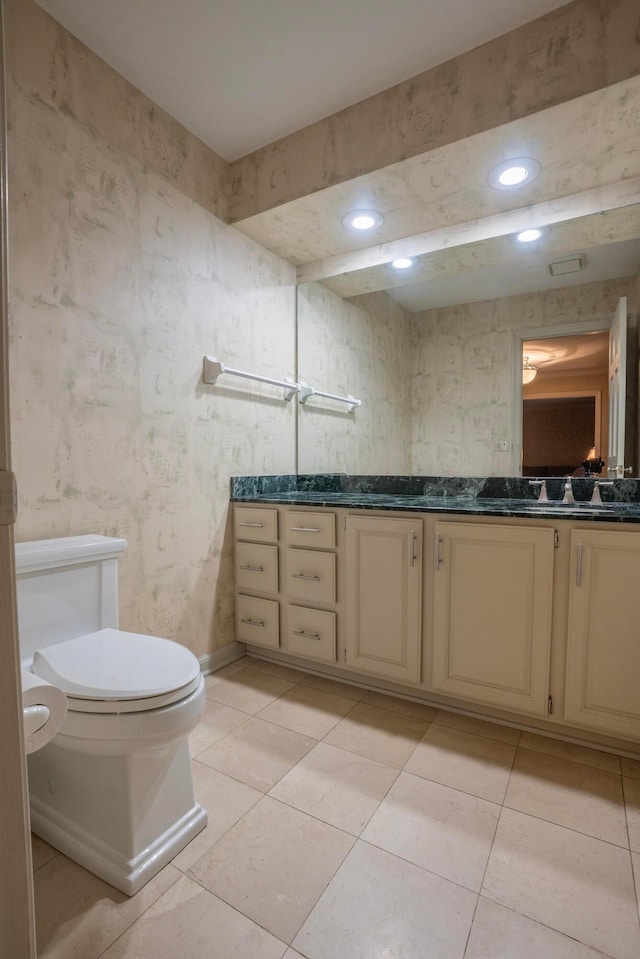 bathroom featuring vanity, toilet, and tile patterned flooring