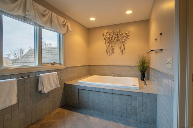 bathroom featuring tiled tub, tile walls, and tile patterned floors