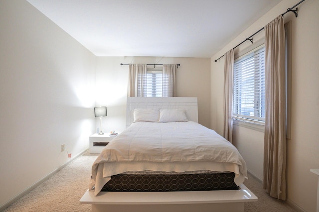 carpeted bedroom featuring multiple windows