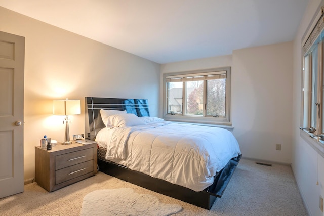 bedroom featuring light carpet