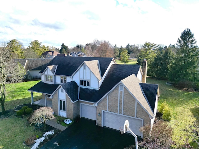 view of front of property featuring a garage and a front lawn