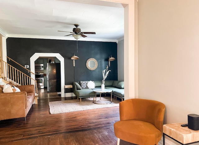 sitting room featuring crown molding, ceiling fan, and dark wood-type flooring