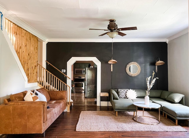 living room featuring dark hardwood / wood-style flooring, crown molding, and ceiling fan