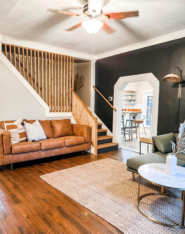 living room featuring crown molding, dark hardwood / wood-style floors, and ceiling fan