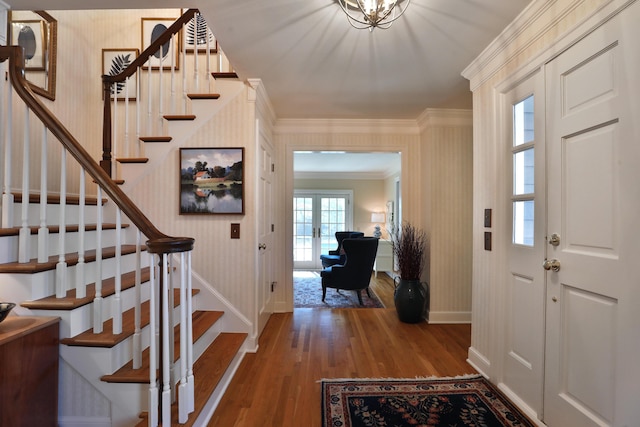 entrance foyer featuring crown molding, hardwood / wood-style flooring, and french doors