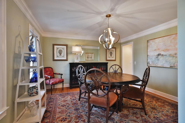 dining space with crown molding, hardwood / wood-style floors, and a notable chandelier