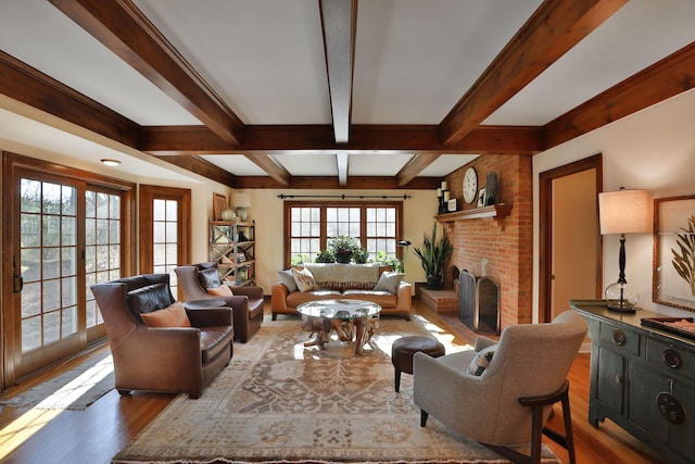 living room featuring dark hardwood / wood-style flooring, a brick fireplace, and beam ceiling