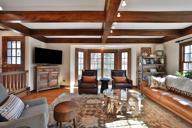 living room featuring light hardwood / wood-style floors and beamed ceiling