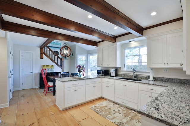 kitchen with white cabinetry and sink