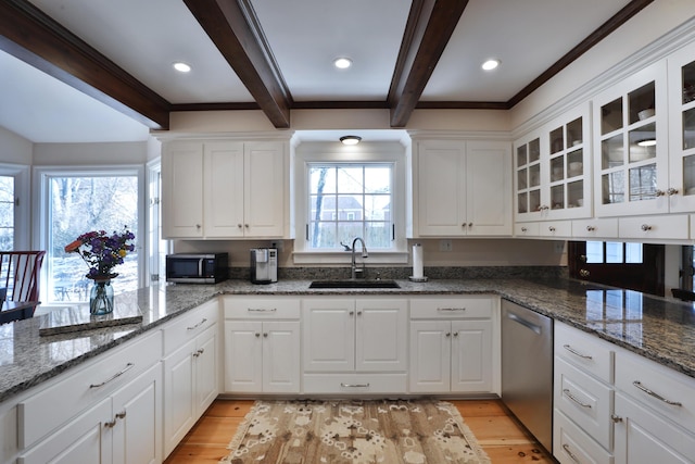 kitchen featuring sink, white cabinetry, appliances with stainless steel finishes, dark stone counters, and light hardwood / wood-style floors