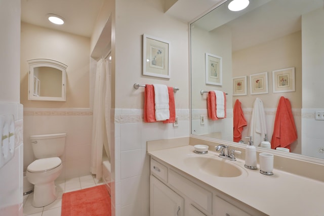 full bathroom with tile walls, vanity, toilet, shower / bath combo, and tile patterned floors