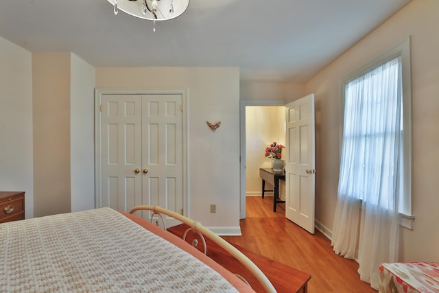 bedroom with a closet and light hardwood / wood-style flooring