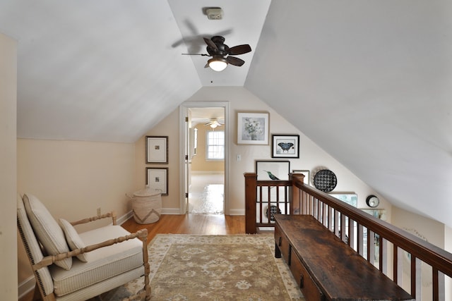 living area with vaulted ceiling and light hardwood / wood-style flooring