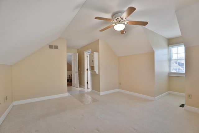 bonus room featuring lofted ceiling, light carpet, and ceiling fan