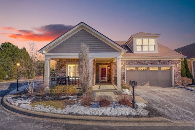 view of front of house featuring a garage and a porch