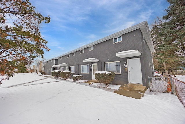 view of snow covered rear of property