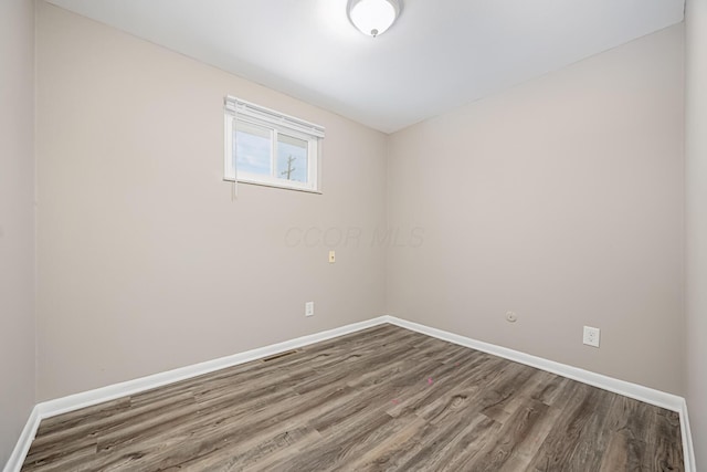 empty room with wood-type flooring