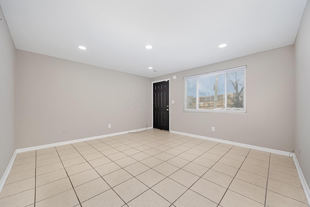 unfurnished room featuring light tile patterned flooring