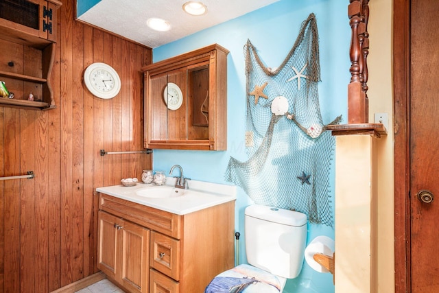 bathroom featuring vanity, toilet, and a textured ceiling