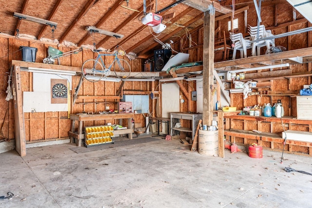 garage with a garage door opener and a workshop area