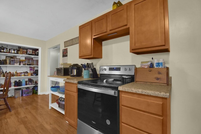 kitchen featuring light hardwood / wood-style flooring and stainless steel range with electric stovetop