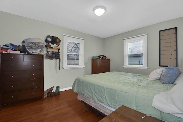 bedroom with dark hardwood / wood-style floors