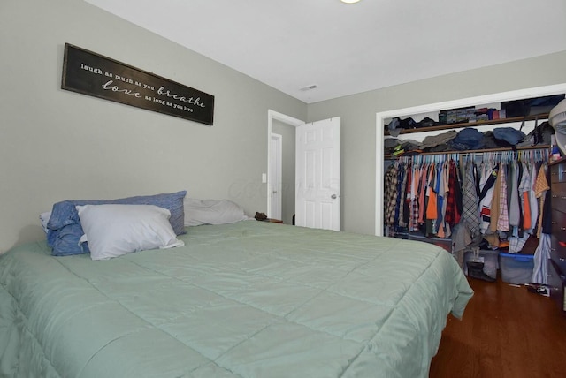 bedroom featuring hardwood / wood-style floors and a closet