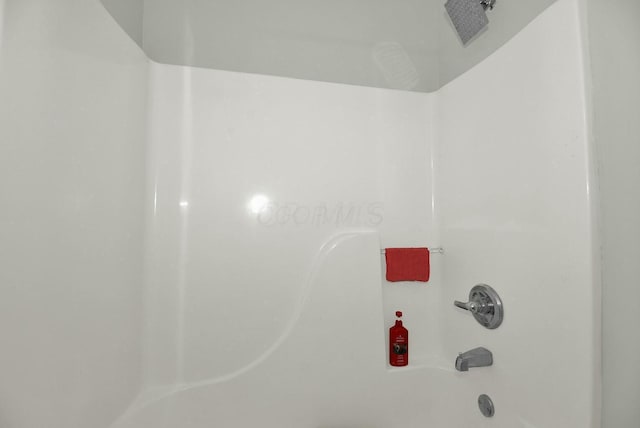 room details featuring shower / washtub combination