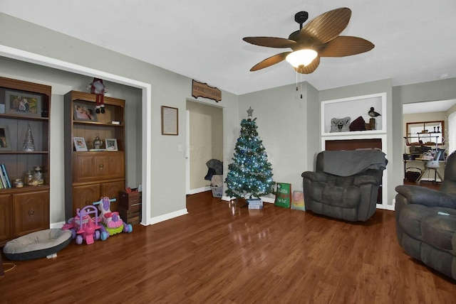 living room featuring ceiling fan and hardwood / wood-style floors